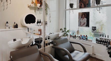 Interior of Cora and Co, Teignmouth, England, showcasing salon chairs and beauty products.