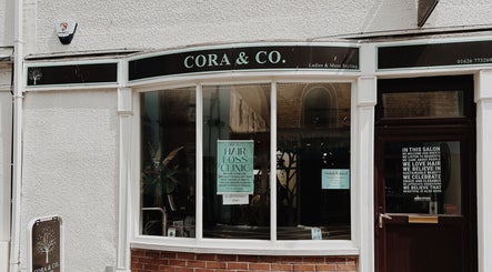 Front view of Cora and Co salon in Teignmouth, England, GB, showcasing its inviting exterior and signage.