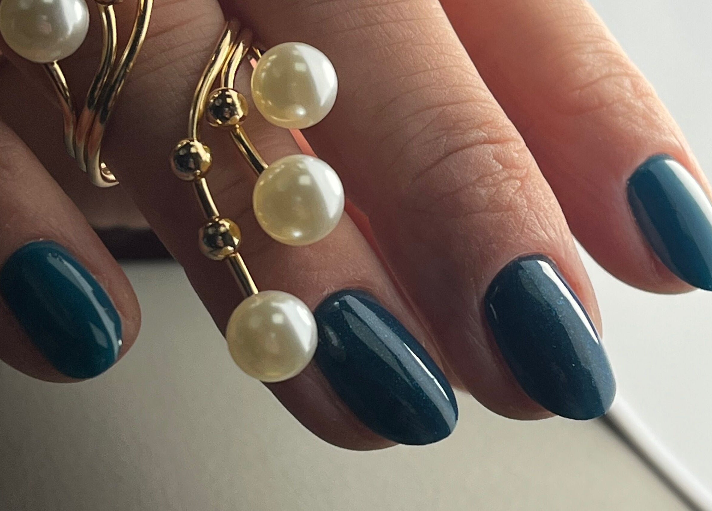 Stylish dark blue manicure with pearl accents at AkvileL Nails, Mullingar, County Westmeath, IE.