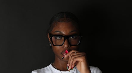 A fashionable individual with trendy glasses at Mula Shots, Leicester, England, GB.
