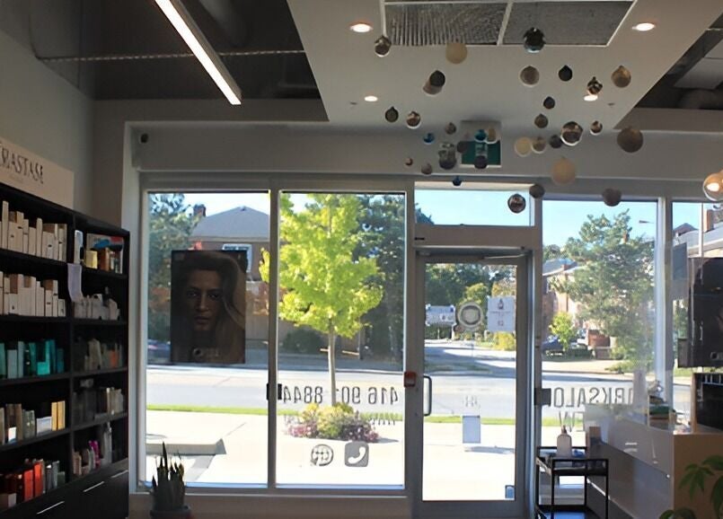 Chic interior of DBK Salon Bayview, Toronto, Ontario, CA, features stylish shelving and modern decor.
