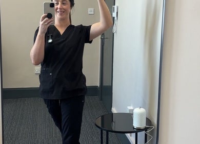 Staff member at CliniK Aesthetics in Irvine, Scotland, GB captures a mirror selfie in a treatment room.