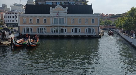 Barcos na frente de um edifício clássico em Aveiro, perto do JFG Clinic, Guimarães, Braga, PT.