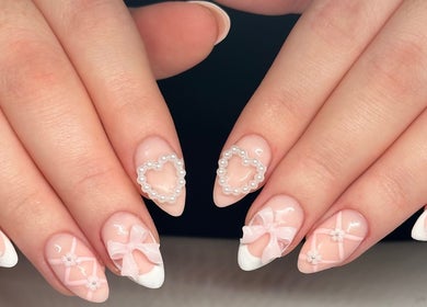 Elegant acrylic nails with pearl heart designs at Nails by Emeli, Halfway, England, GB.