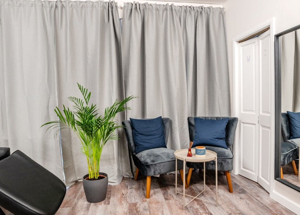 Relaxing seating area at Beayou clinic, Bromley, England with elegant decor and cozy chairs.