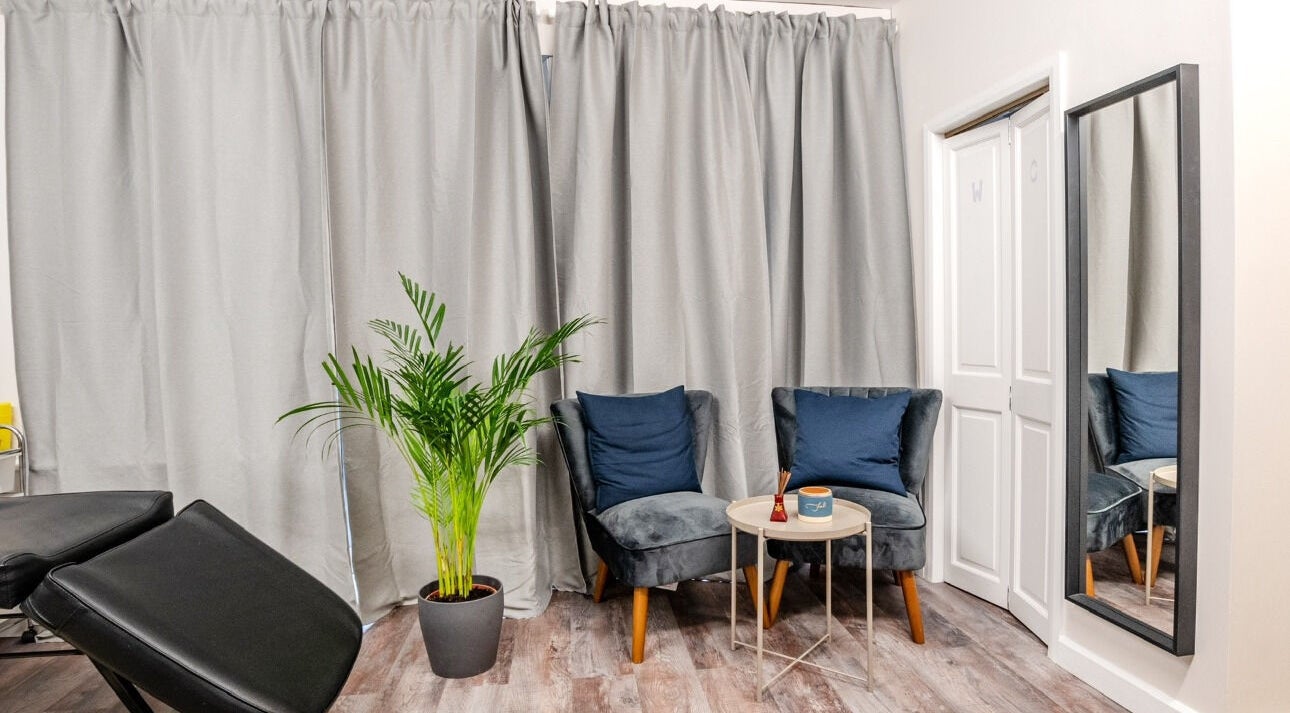Relaxing seating area at Beayou clinic, Bromley, England with elegant decor and cozy chairs.