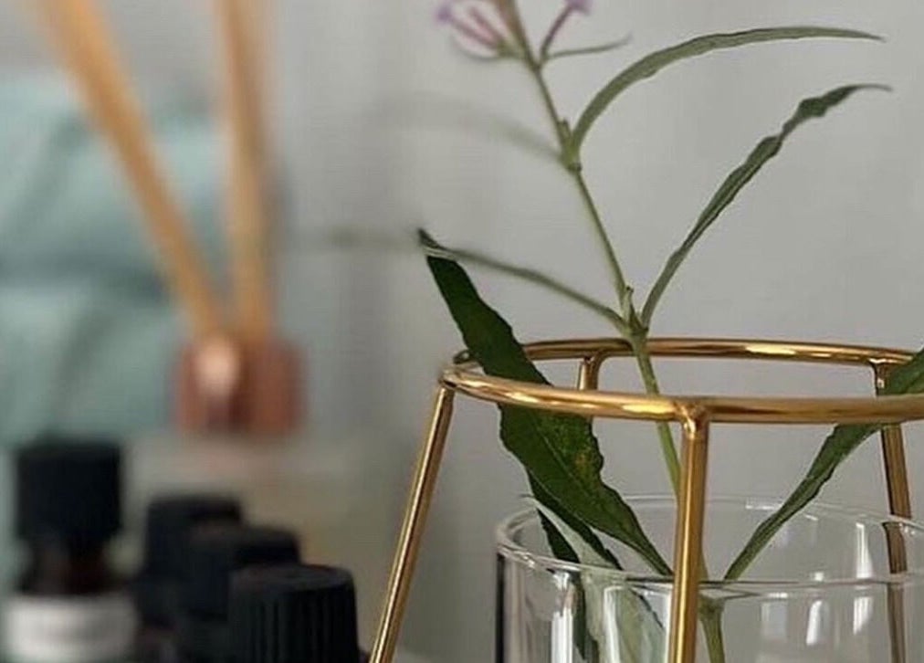 Elegant aromatherapy setup at Beayou Clinic, Bromley, England, GB, featuring oils and a decorative vase.