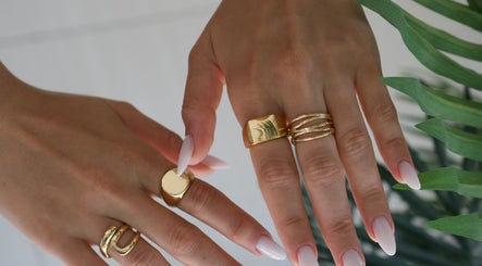 Elegant hands with gold rings at Lash Design - River North, Chicago, Illinois, US.