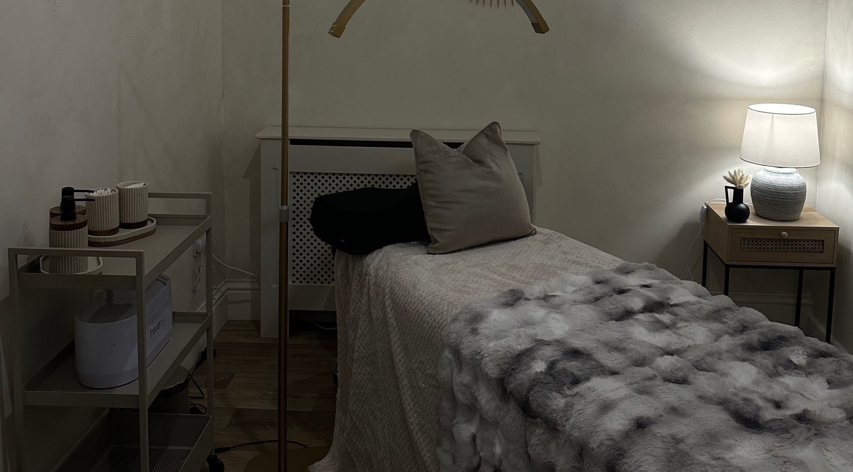 Relaxing spa room at Coconut & Co, Penrith, England, GB, featuring a softly lit massage table and stylish decor.