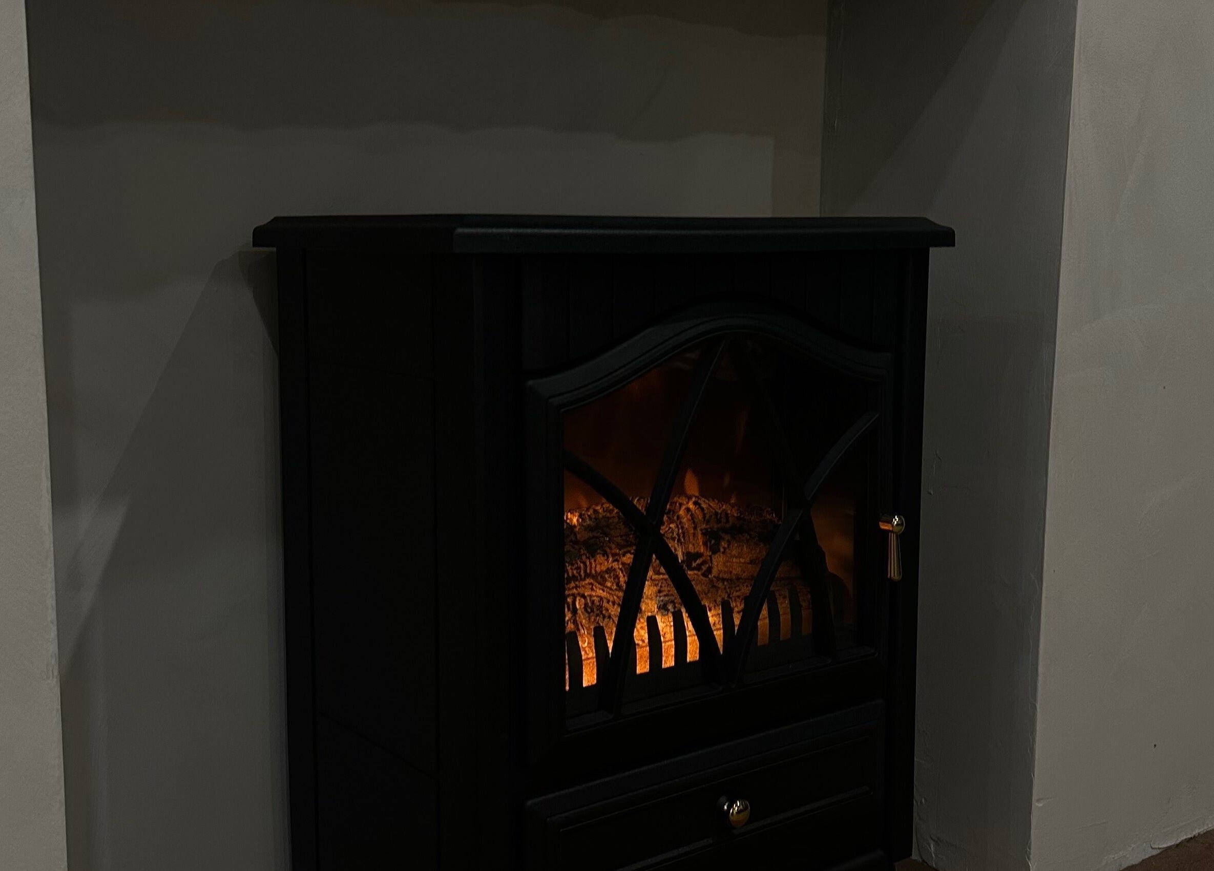 Elegant electric fireplace at Coconut & Co, Penrith, England, GB adds warmth to the relaxing ambiance.