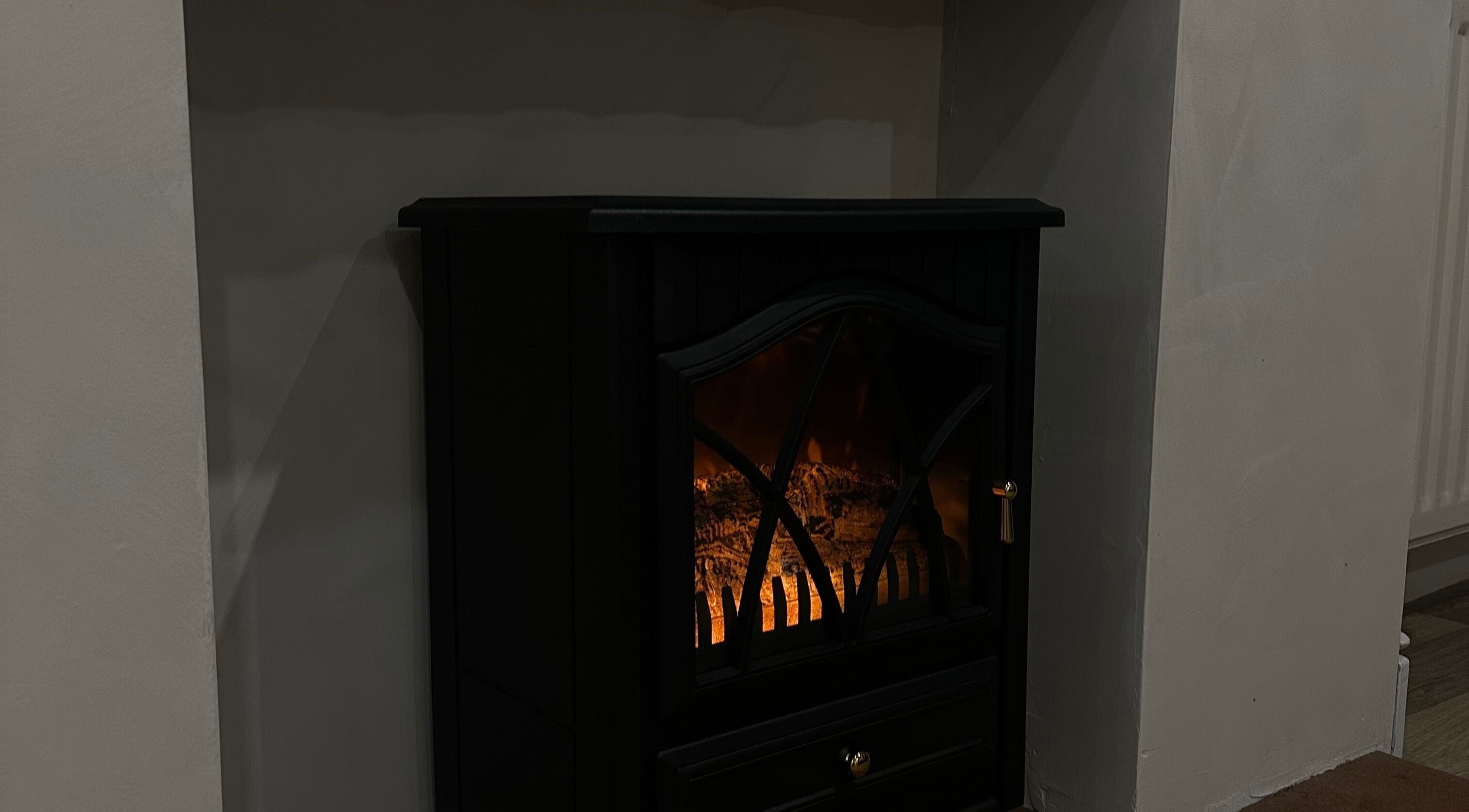 Elegant electric fireplace at Coconut & Co, Penrith, England, GB adds warmth to the relaxing ambiance.
