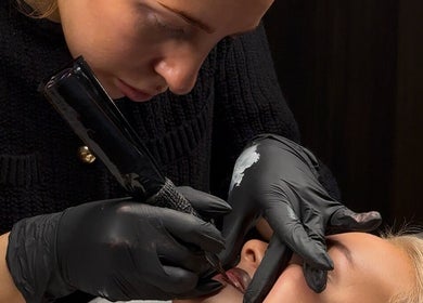 Expert applying lip tattoo at Coconut & Co, Penrith, England, GB, ensuring flawless beauty and precision.