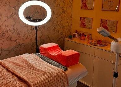 Treatment room at The Glow Room by Danielle, Pontypridd, Wales, GB showcasing a massage table with ambient lighting.