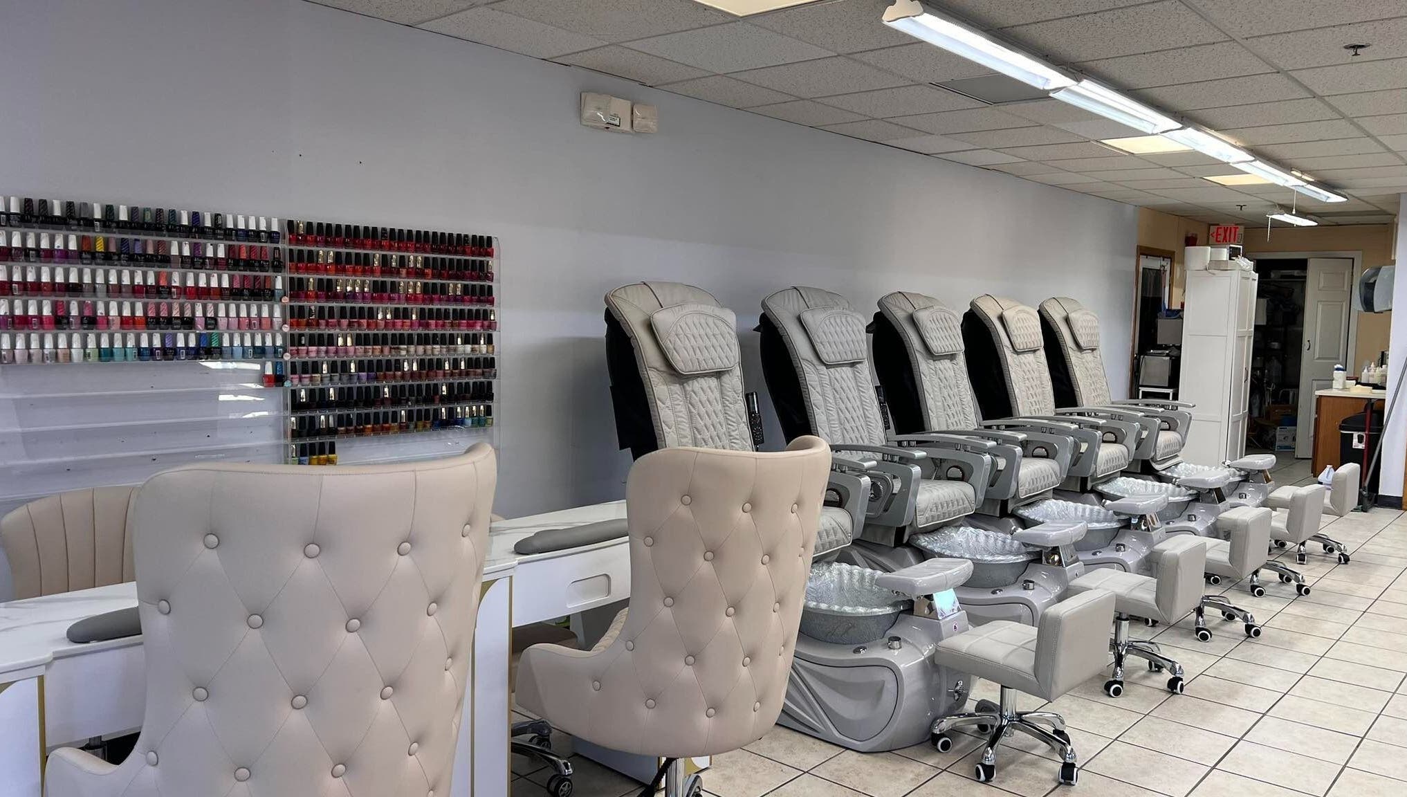 Diva Nails in Methuen, Massachusetts offers luxurious pedicure chairs and a vast polish selection wall.