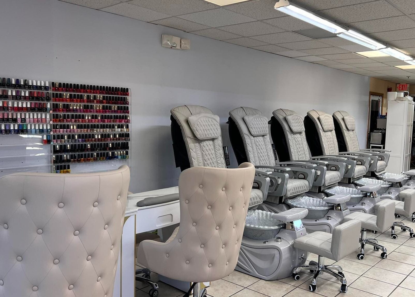 Diva Nails in Methuen, Massachusetts offers luxurious pedicure chairs and a vast polish selection wall.