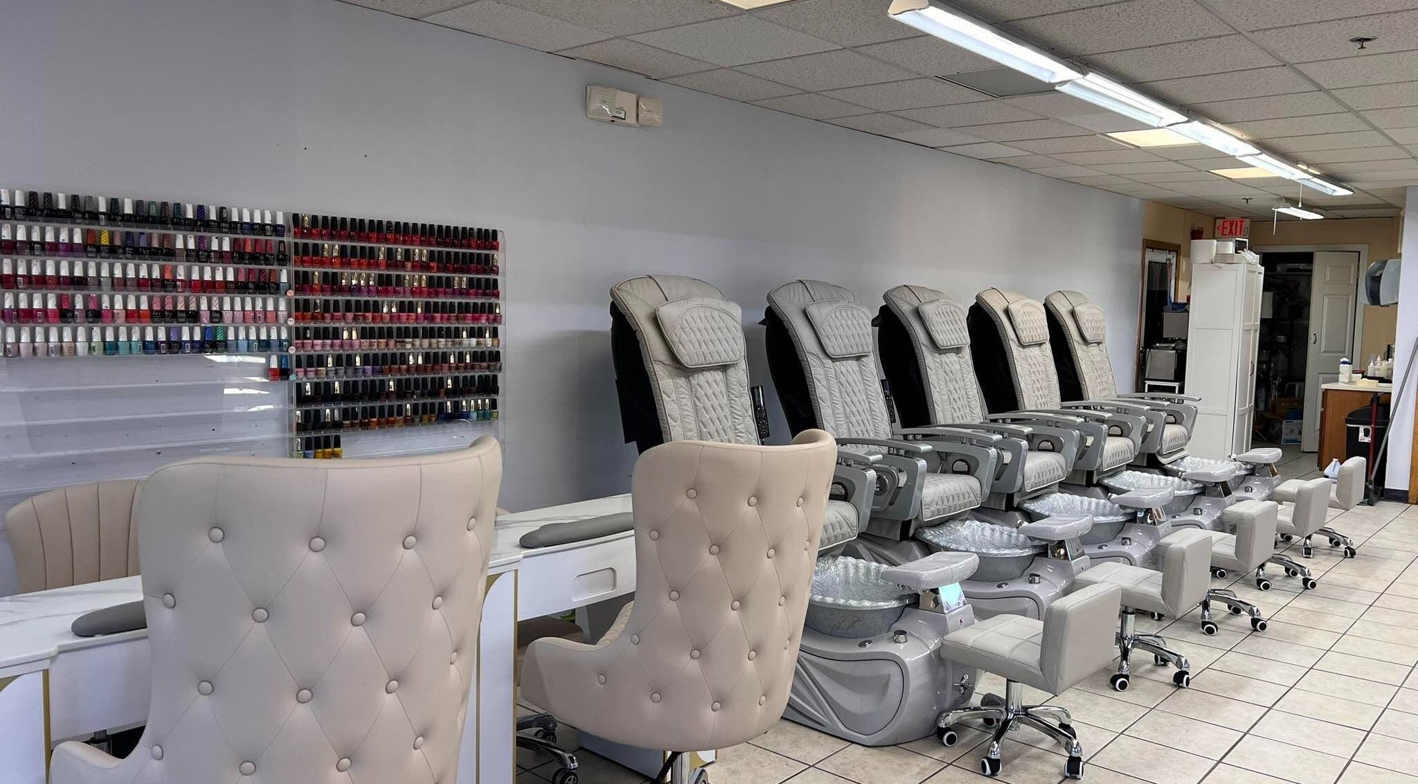 Diva Nails in Methuen, Massachusetts offers luxurious pedicure chairs and a vast polish selection wall.