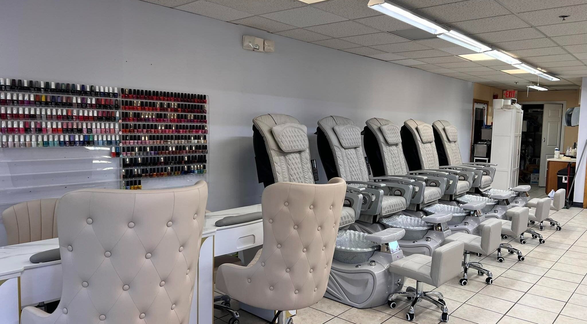 Diva Nails in Methuen, Massachusetts offers luxurious pedicure chairs and a vast polish selection wall.