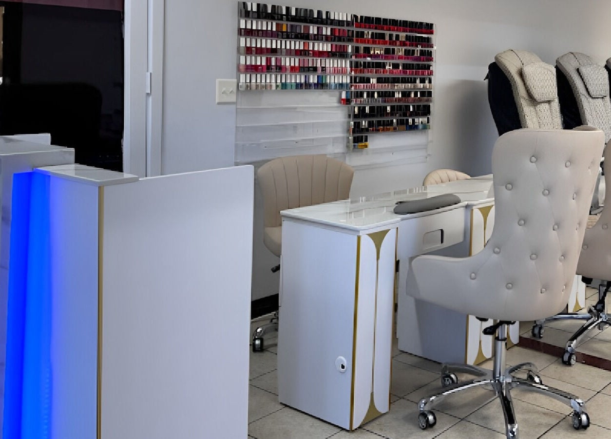 Elegant nail salon setup at Diva Nails in Methuen, Massachusetts, US with plush chairs and nail polish display.
