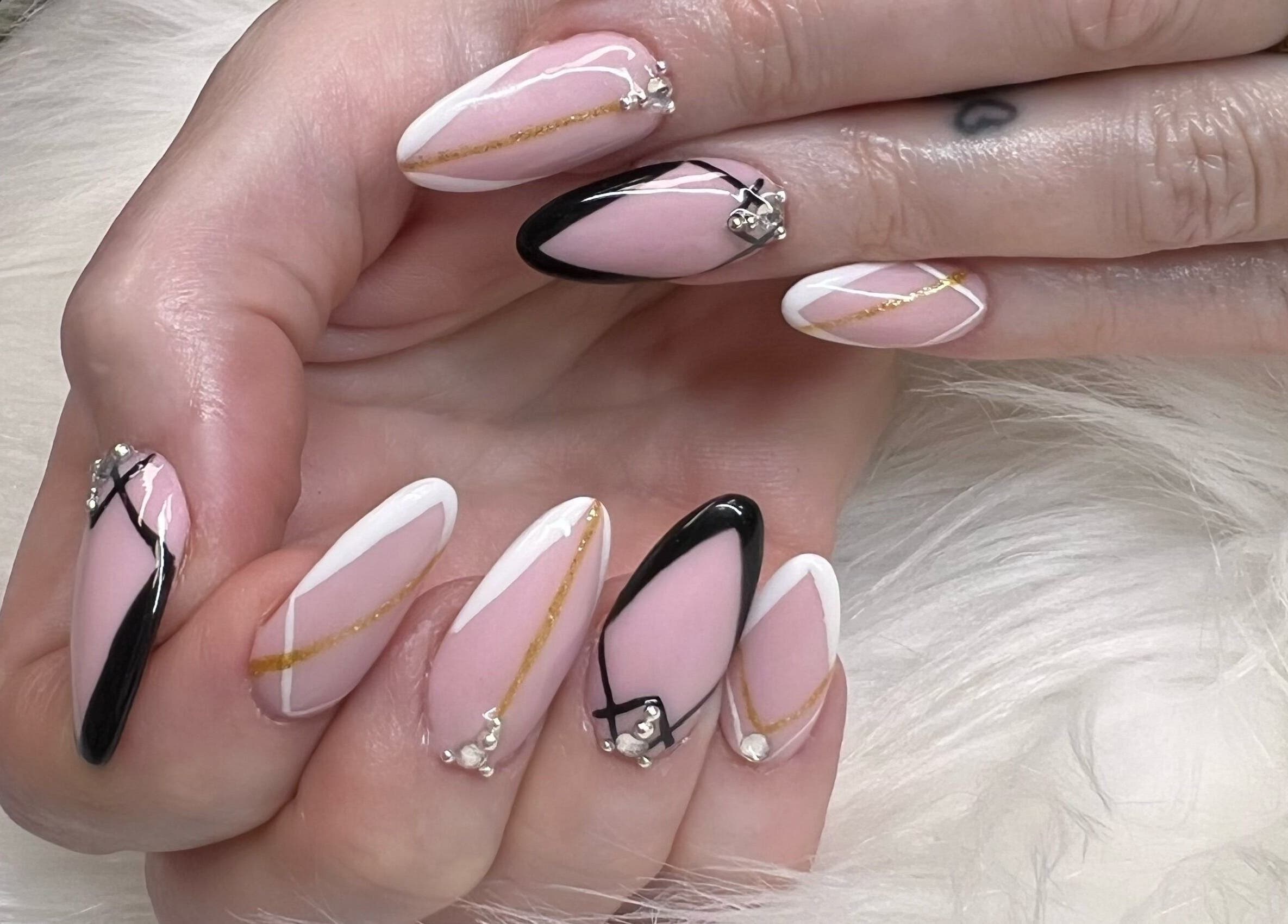 Elegant nail art with pink and black designs at Diva Nails, Methuen, Massachusetts, US.