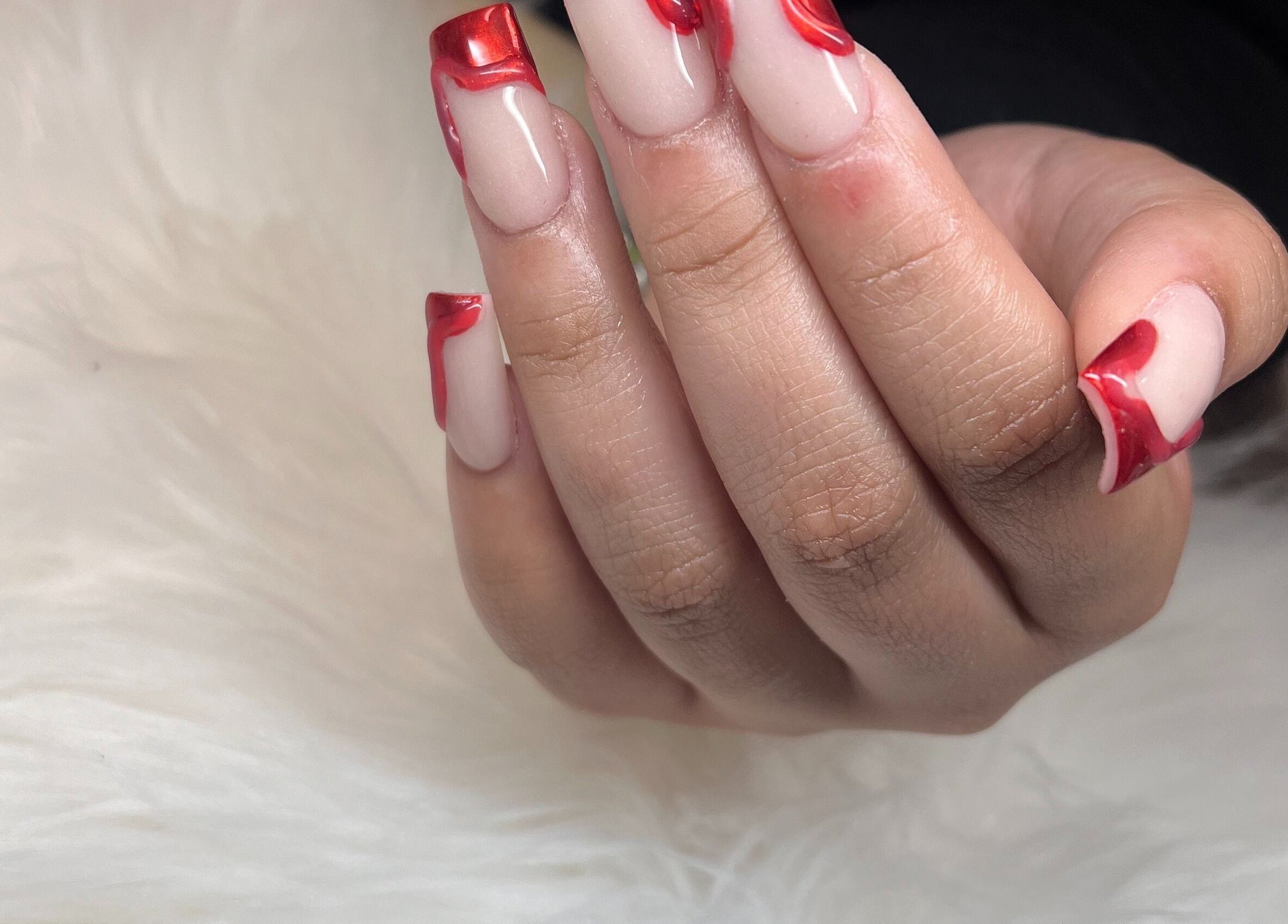 Red-tipped nail art at Diva Nails, Methuen, Massachusetts, US. Perfect for bold style enthusiasts.