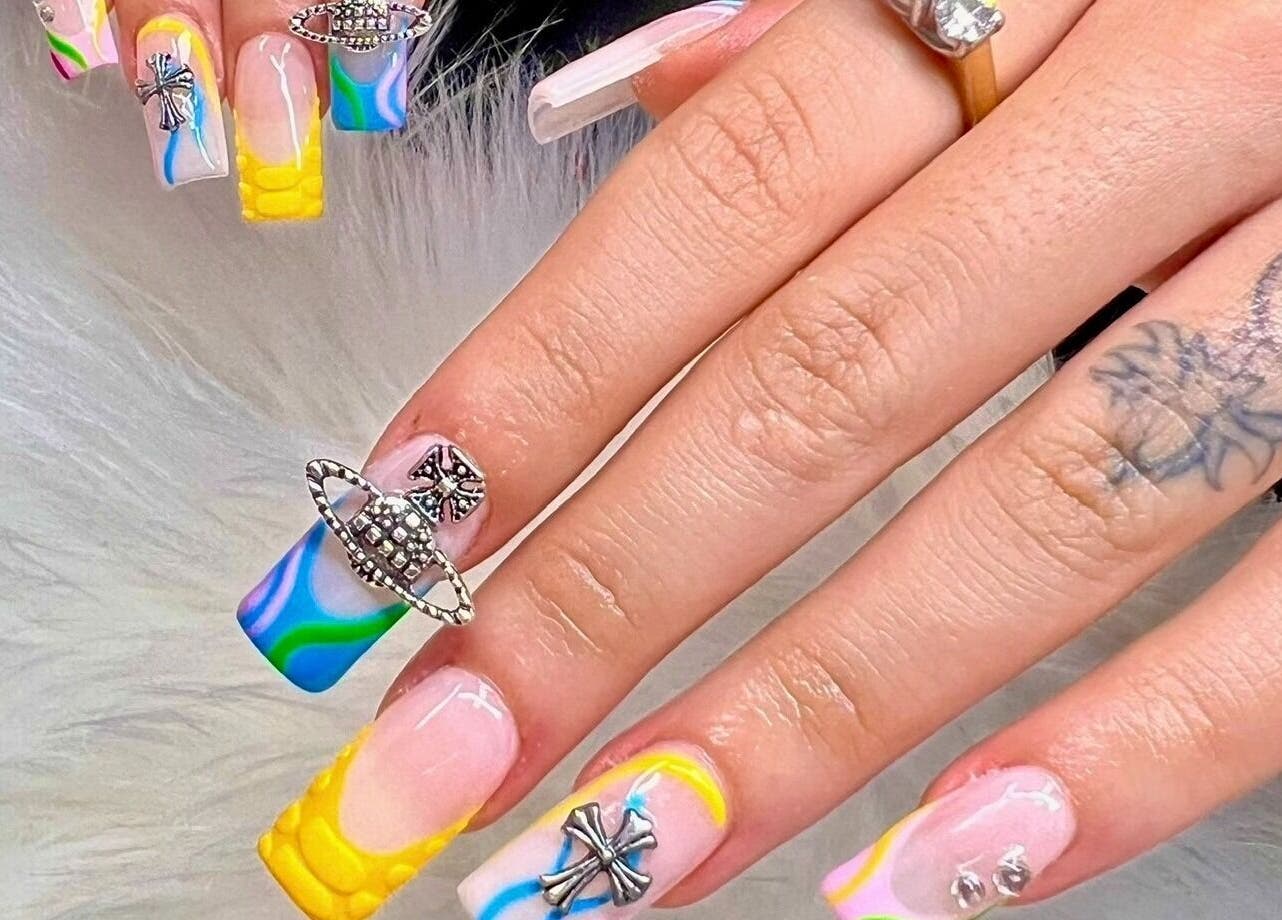 Vibrant nail art with charms at Diva Nails in Methuen, Massachusetts, US.