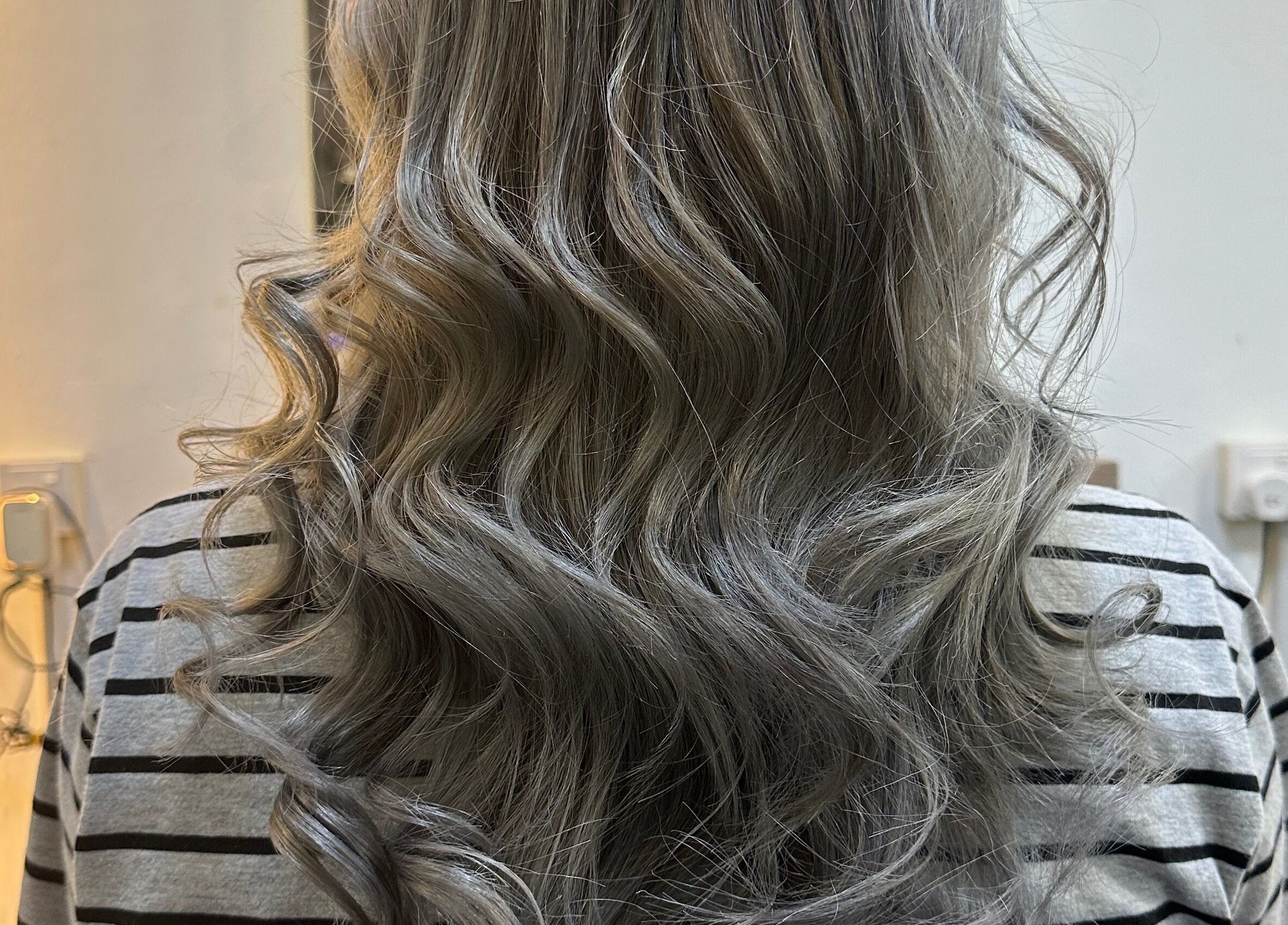 Elegant silver curls styled at Hair Lover Salon, Klang, Selangor, MY. Enhance your beauty with expert touch.