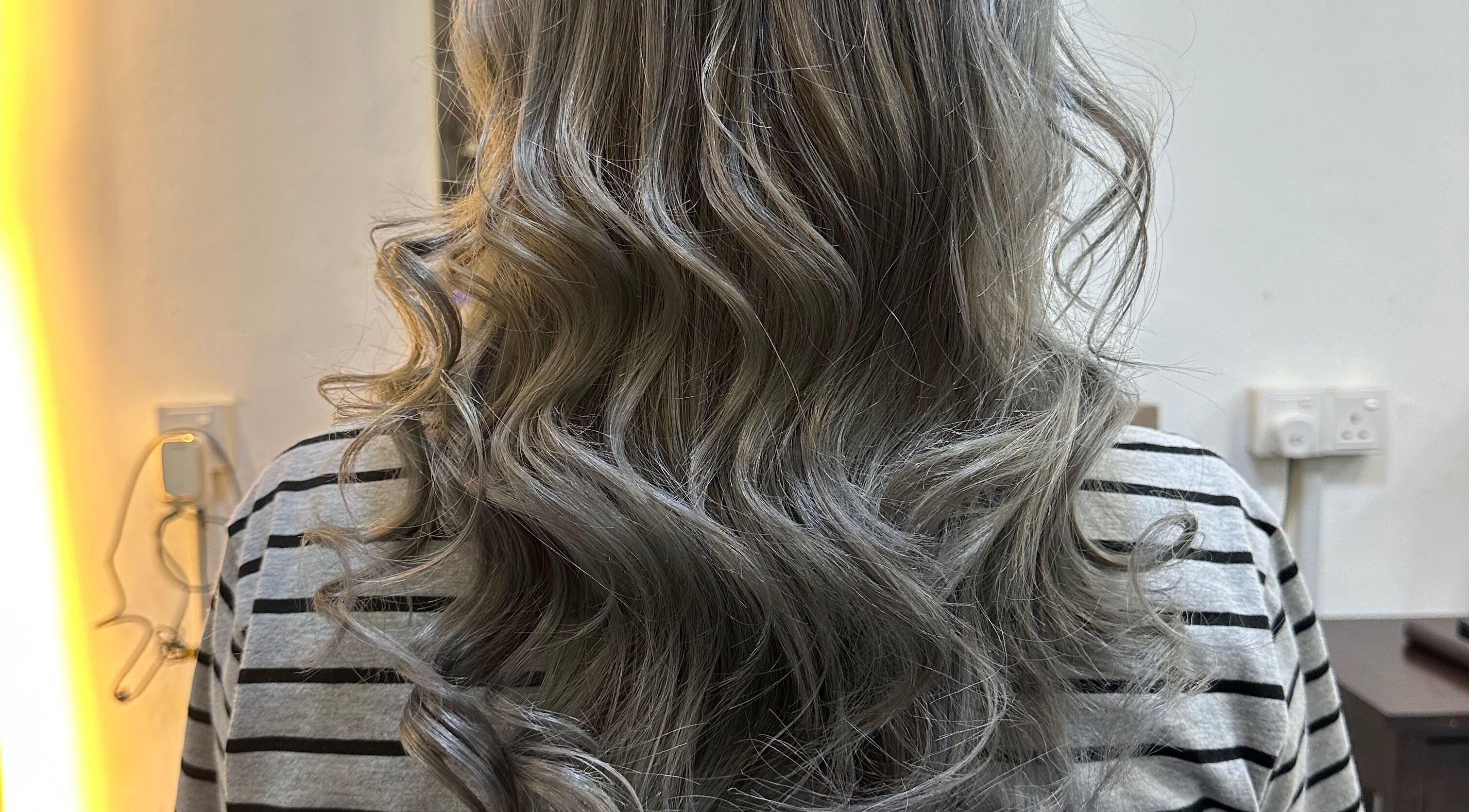Elegant silver curls styled at Hair Lover Salon, Klang, Selangor, MY. Enhance your beauty with expert touch.