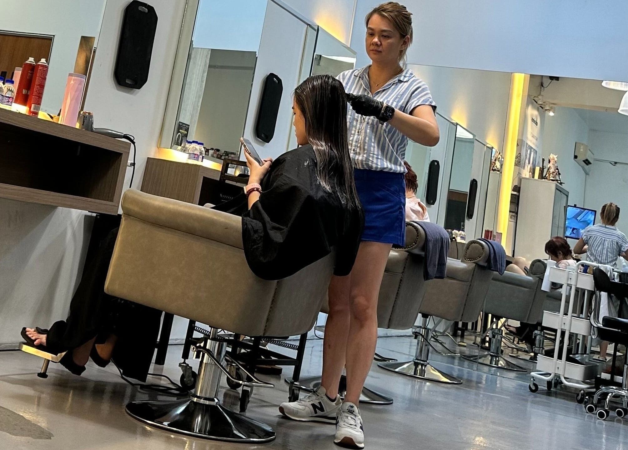 Stylist working on client's hair at Hair Lover Salon in Klang, Selangor, MY.