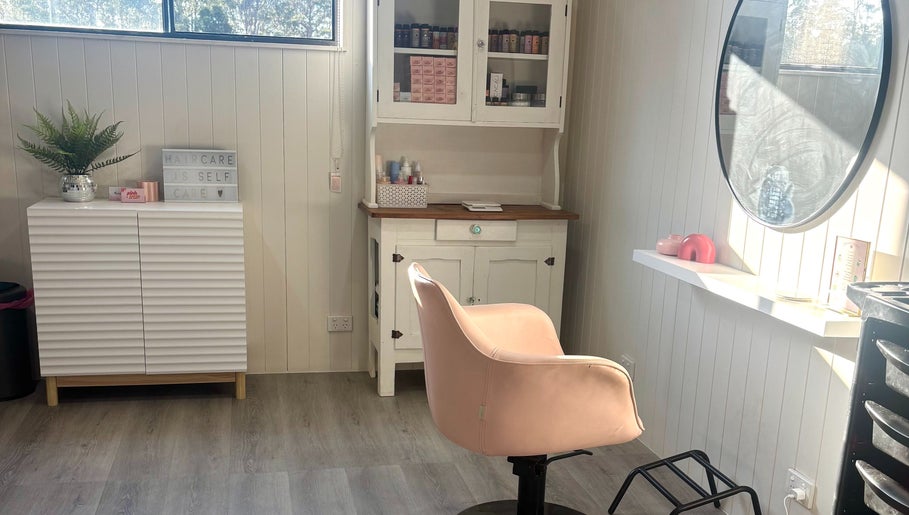 Chic salon interior with pink chair at Pink Honey Hair Studio, Lake Macdonald, Queensland, AU.