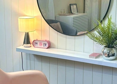 Stylish interior of Pink Honey Hair Studio in Lake Macdonald, Queensland, AU with mirror, chair, and decor.