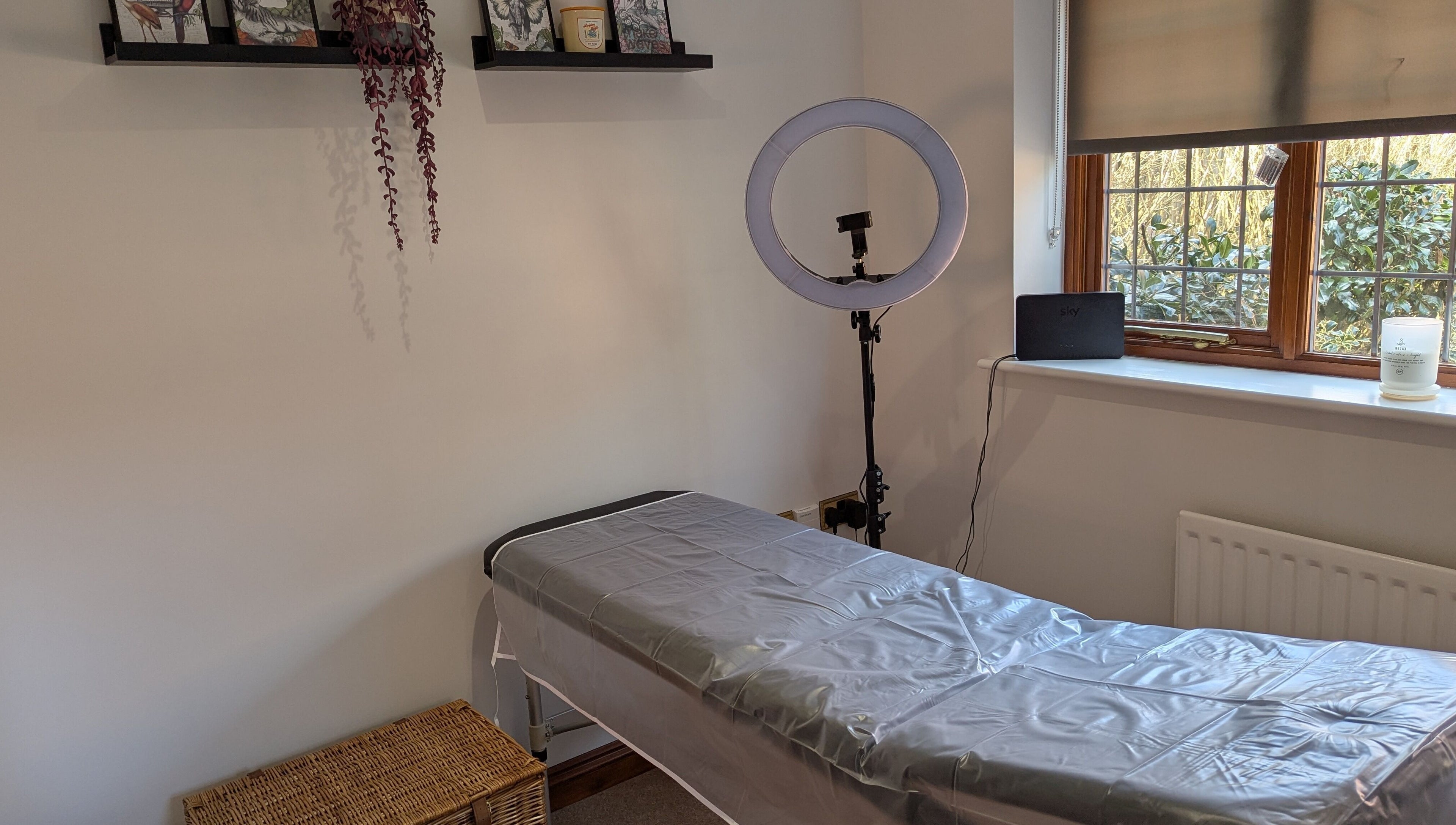 Cozy treatment room at Brows by Bettina in Tadley, England featuring a massage table and soft natural light.