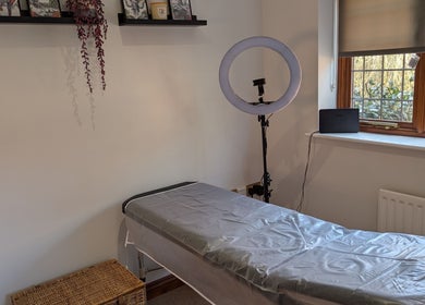 Cozy treatment room at Brows by Bettina in Tadley, England featuring a massage table and soft natural light.