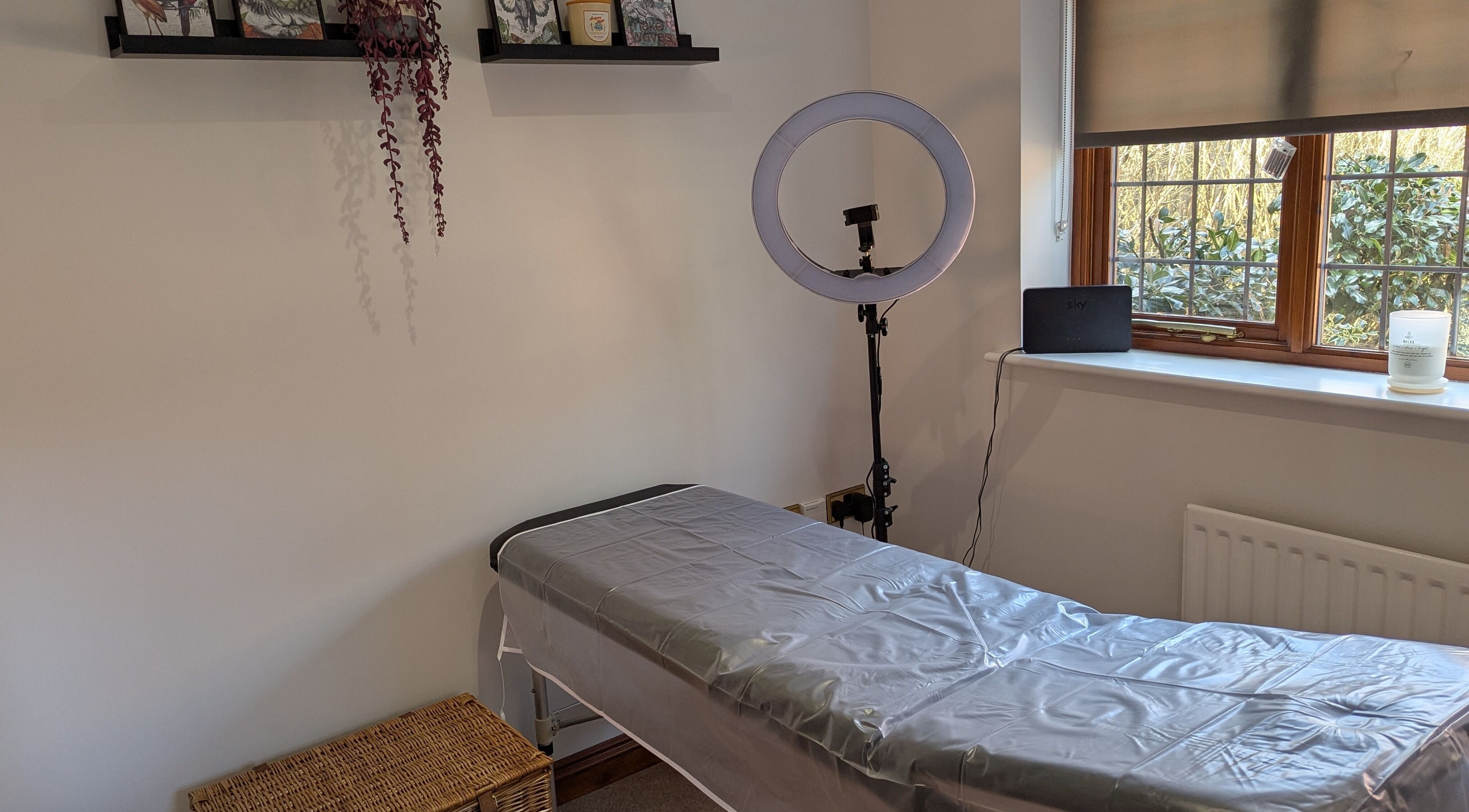 Cozy treatment room at Brows by Bettina in Tadley, England featuring a massage table and soft natural light.