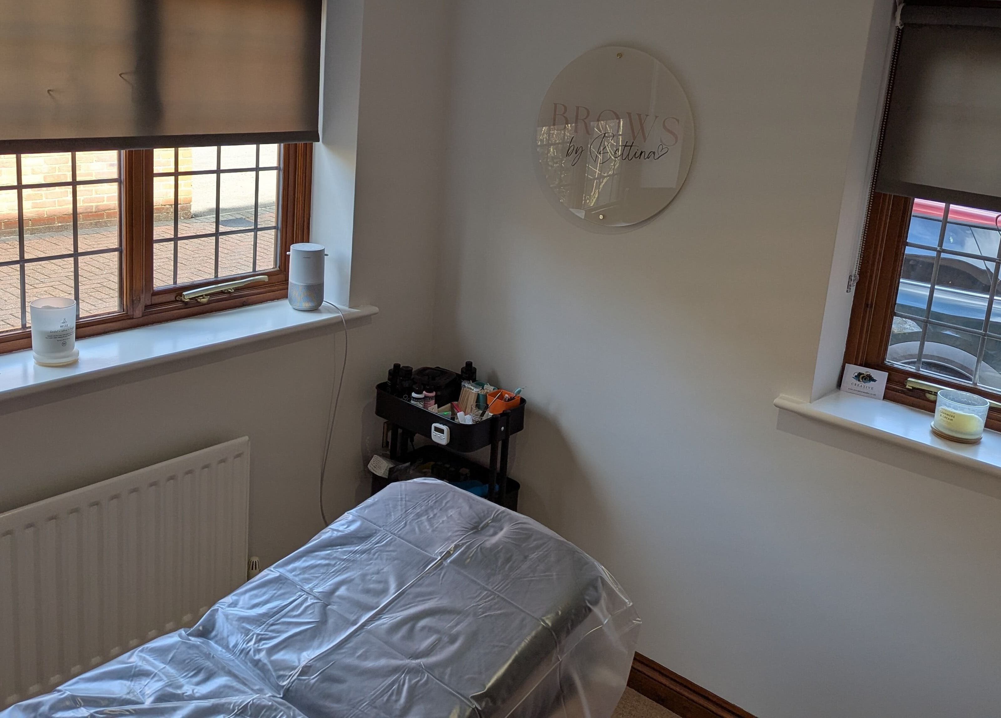 Tranquil treatment room at Brows by Bettina, Tadley, England, GB with natural light and comfortable setup.