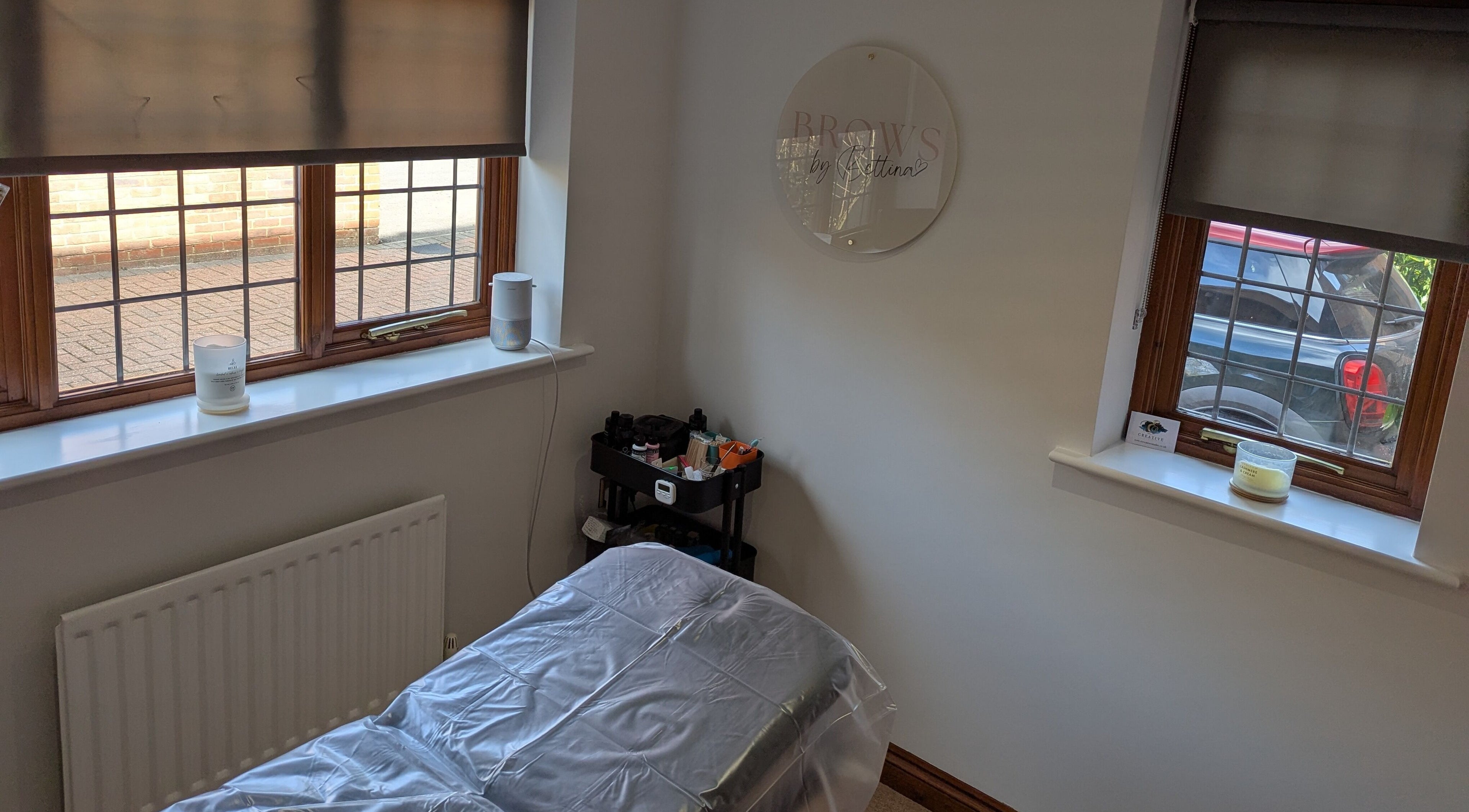 Tranquil treatment room at Brows by Bettina, Tadley, England, GB with natural light and comfortable setup.