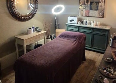 Relaxing treatment room at Zen Den Beauty and Wellbeing Centre, Humberston, GB, with a cozy massage table.