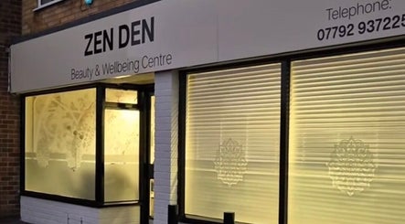 Exterior of Zen Den Beauty and Wellbeing Centre, Humberston, GB, with illuminated windows and signage.