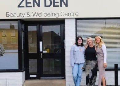 Front of Zen Den Beauty and Wellbeing Centre in Humberston, GB, with three people smiling outside.