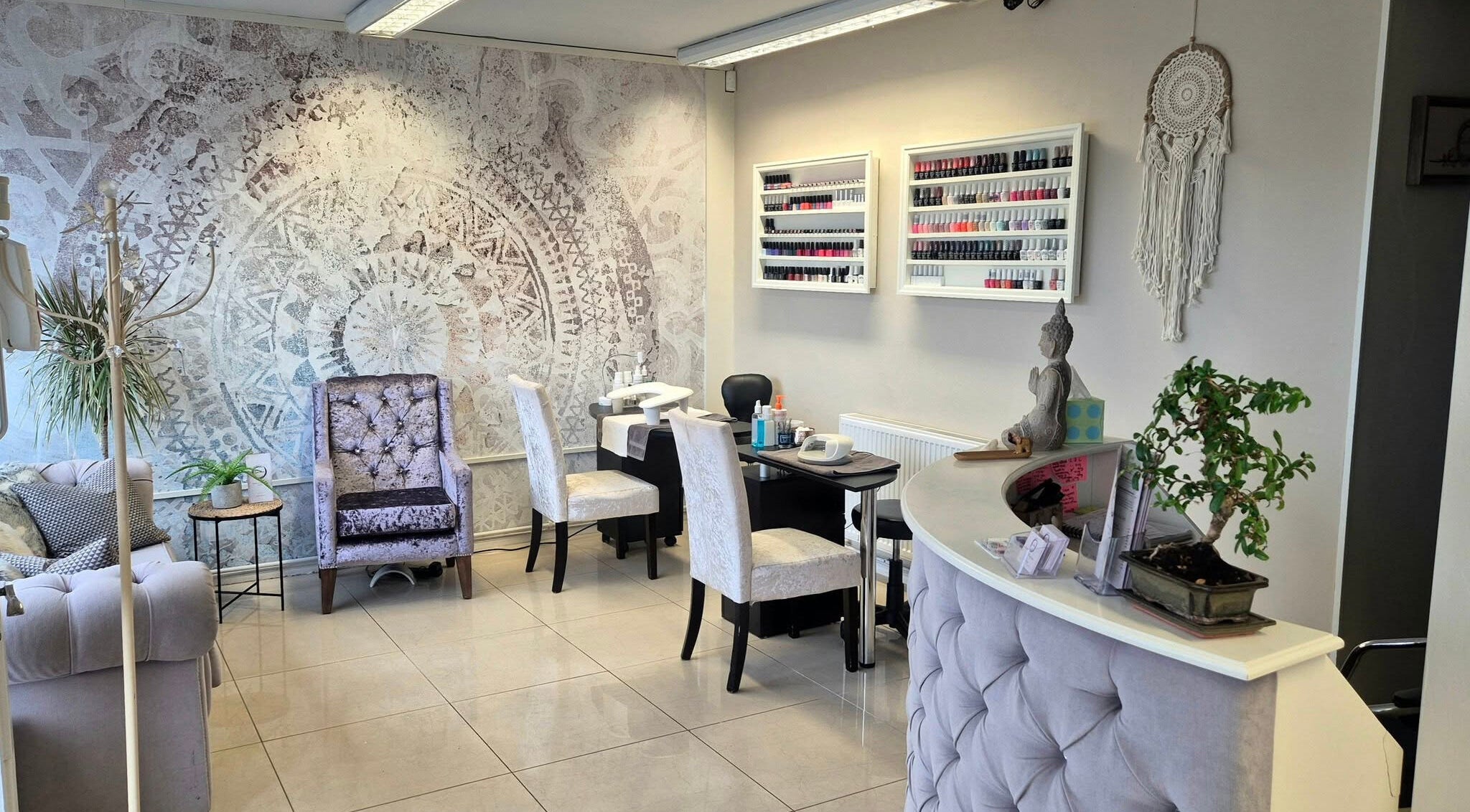 Calm interior of Zen Den Beauty and Wellbeing Centre, Humberston, GB, showcasing nail desks and plush seating.