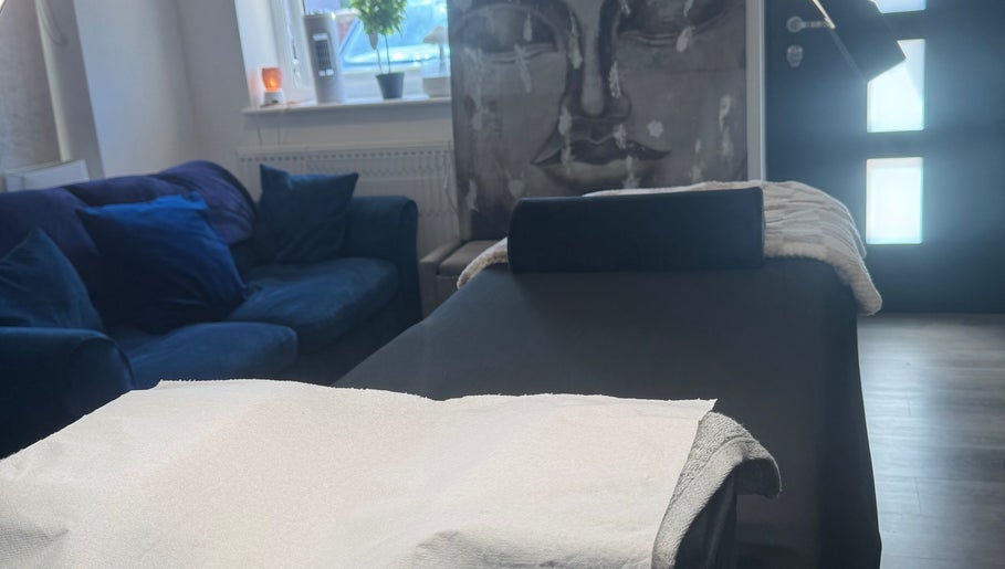 Relaxing treatment area at Glambylilymay, Hadleigh, England, GB. Features a massage bed and cozy seating.