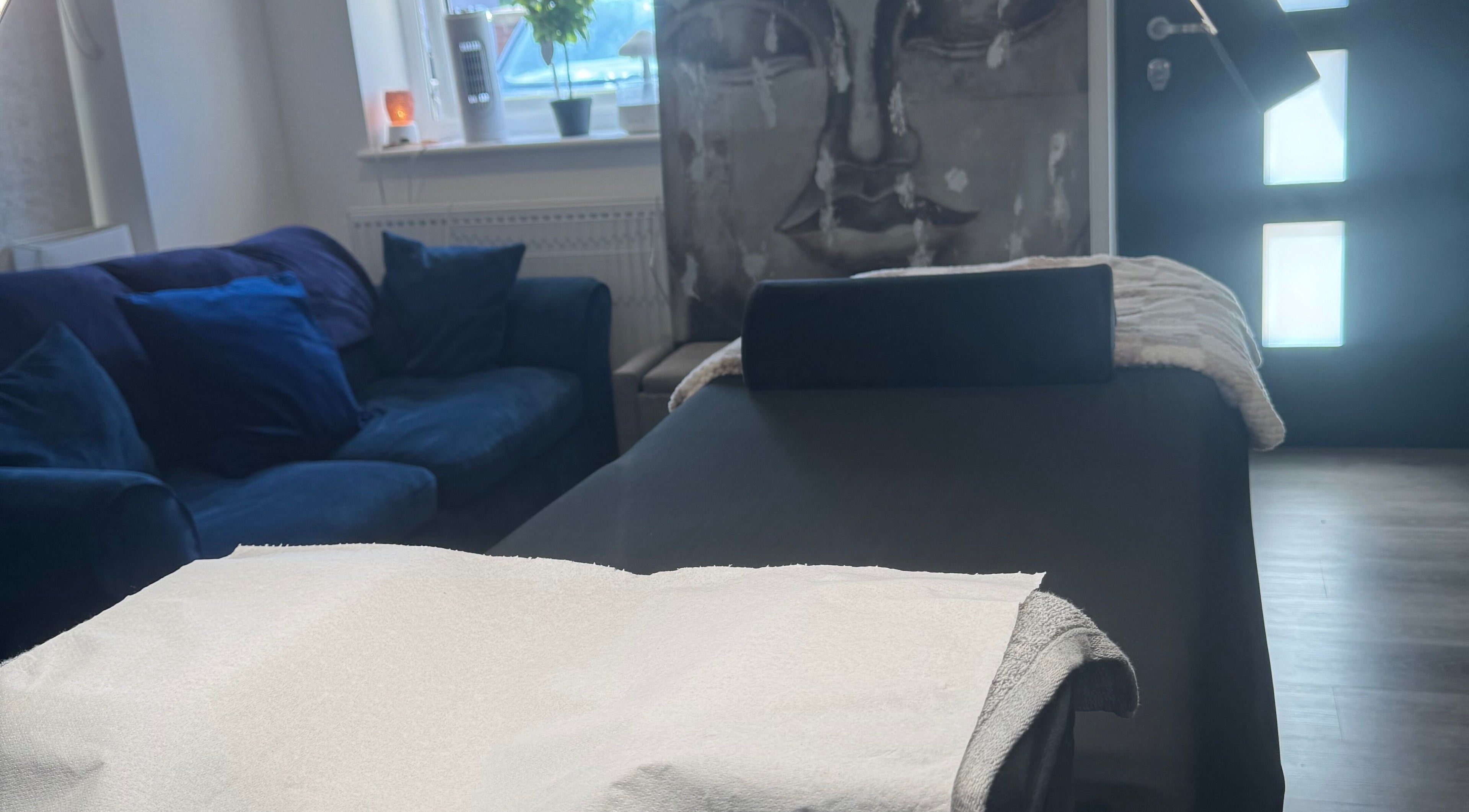 Relaxing treatment area at Glambylilymay, Hadleigh, England, GB. Features a massage bed and cozy seating.