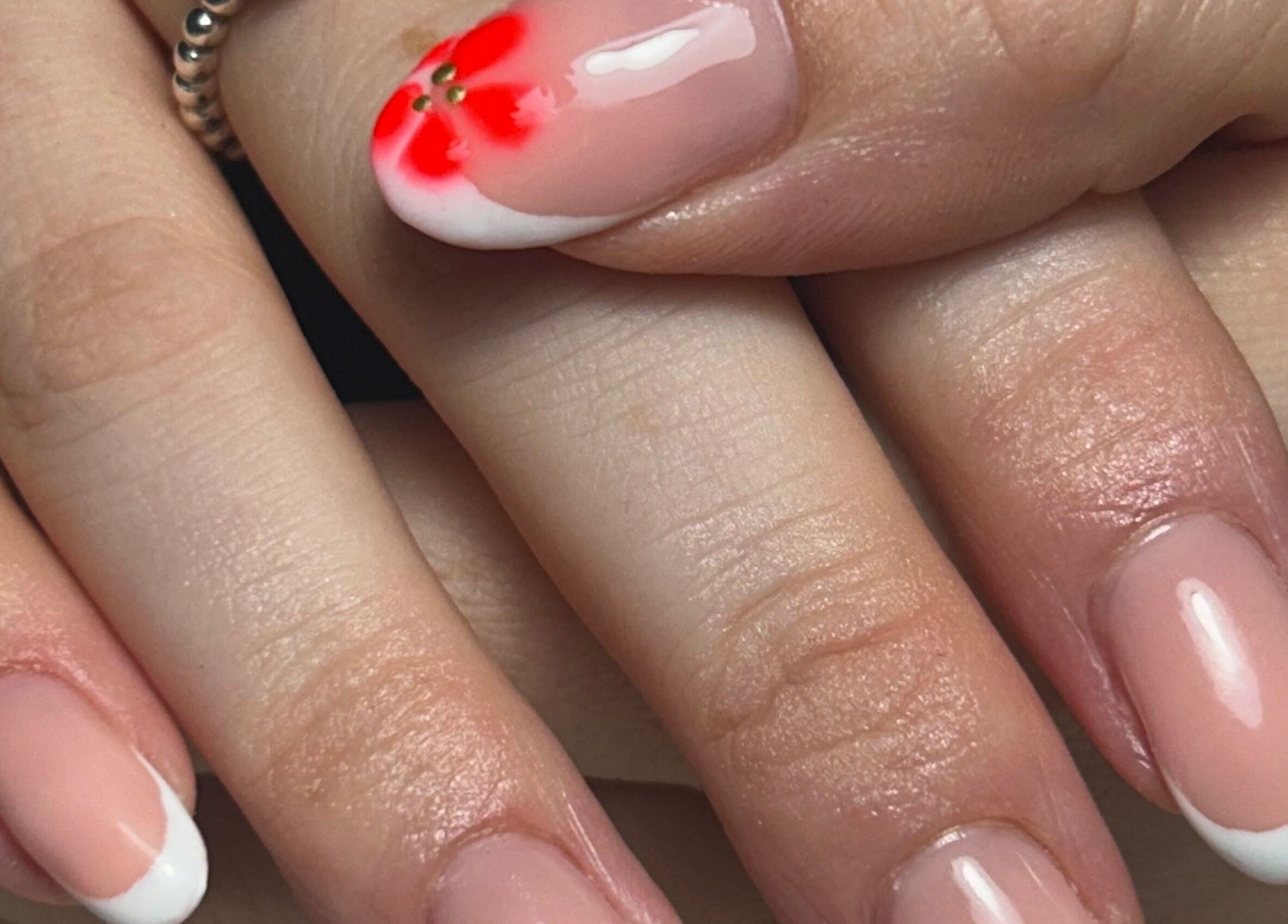 Stylish French manicure with floral art at nailsbyaoifemc, Derry, Northern Ireland, GB.