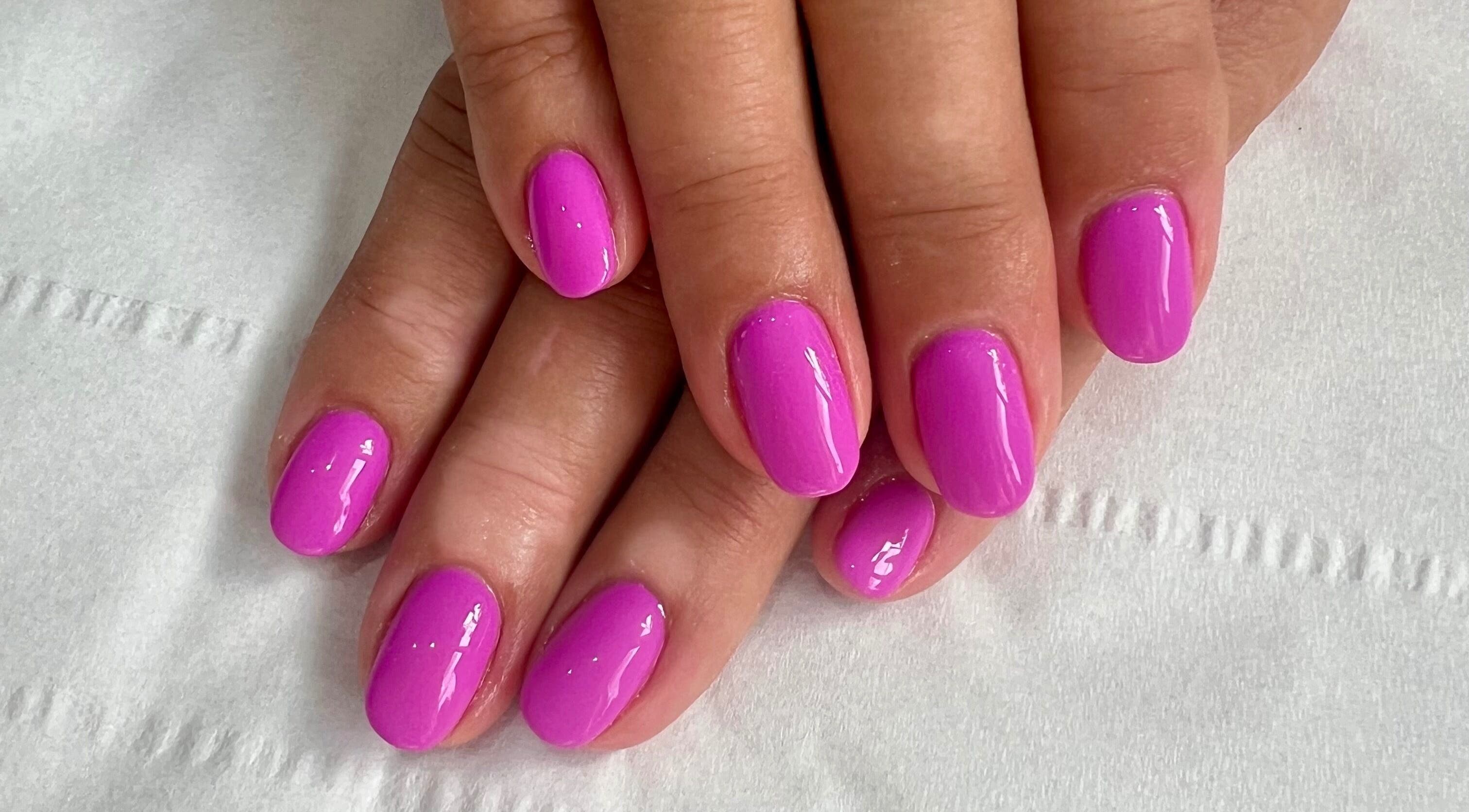 Bright violet manicure at Younger Beauty, Preston, England, GB. Perfectly polished and vibrant nail art.