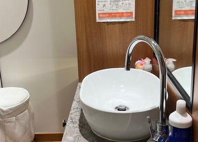 Modern sink area in Chatswood wellness venue, Chatswood, New South Wales, AU with wooden accents and elegant fixtures.