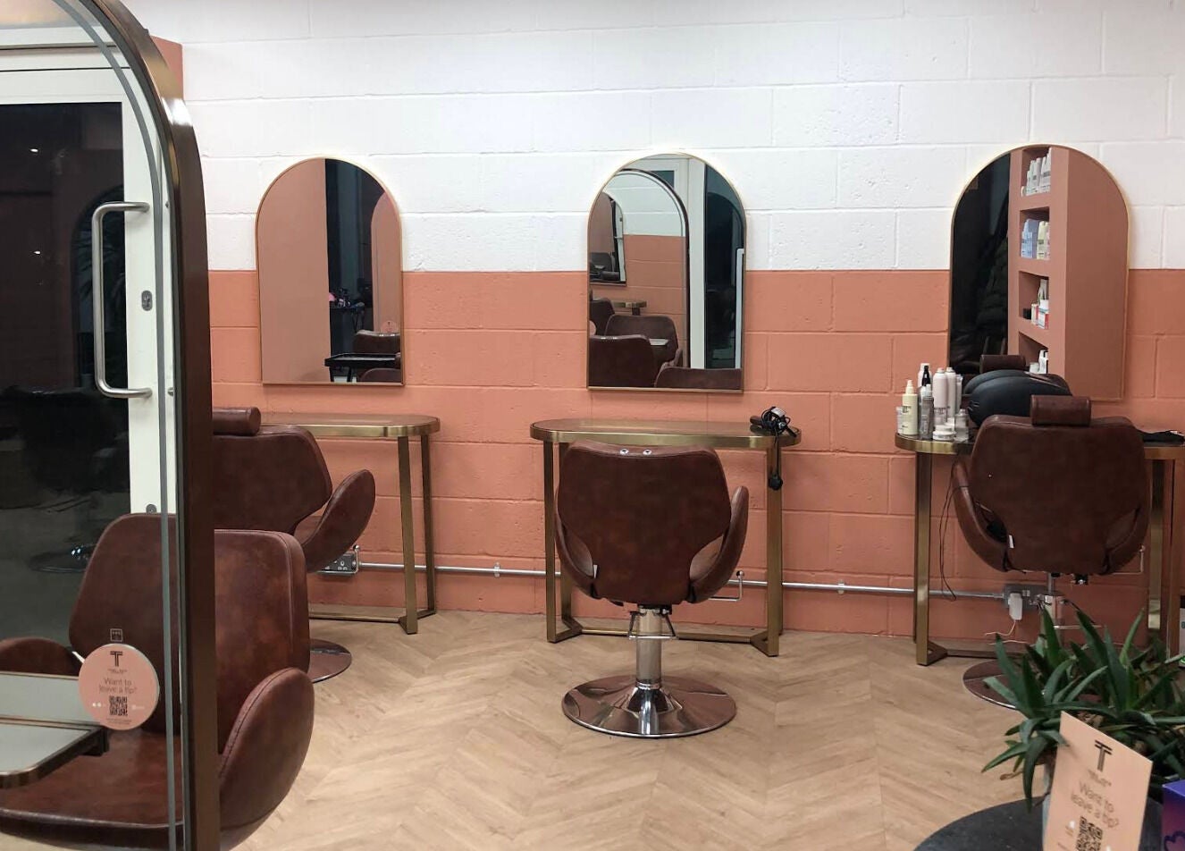 Interior of The Tribu Collective in London, England, GB with elegant salon chairs and mirrors in a chic setting.