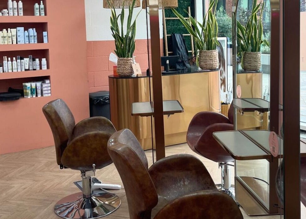 Elegant salon setup at The Tribu Collective in London, England, GB, featuring stylish chairs and lush plants.