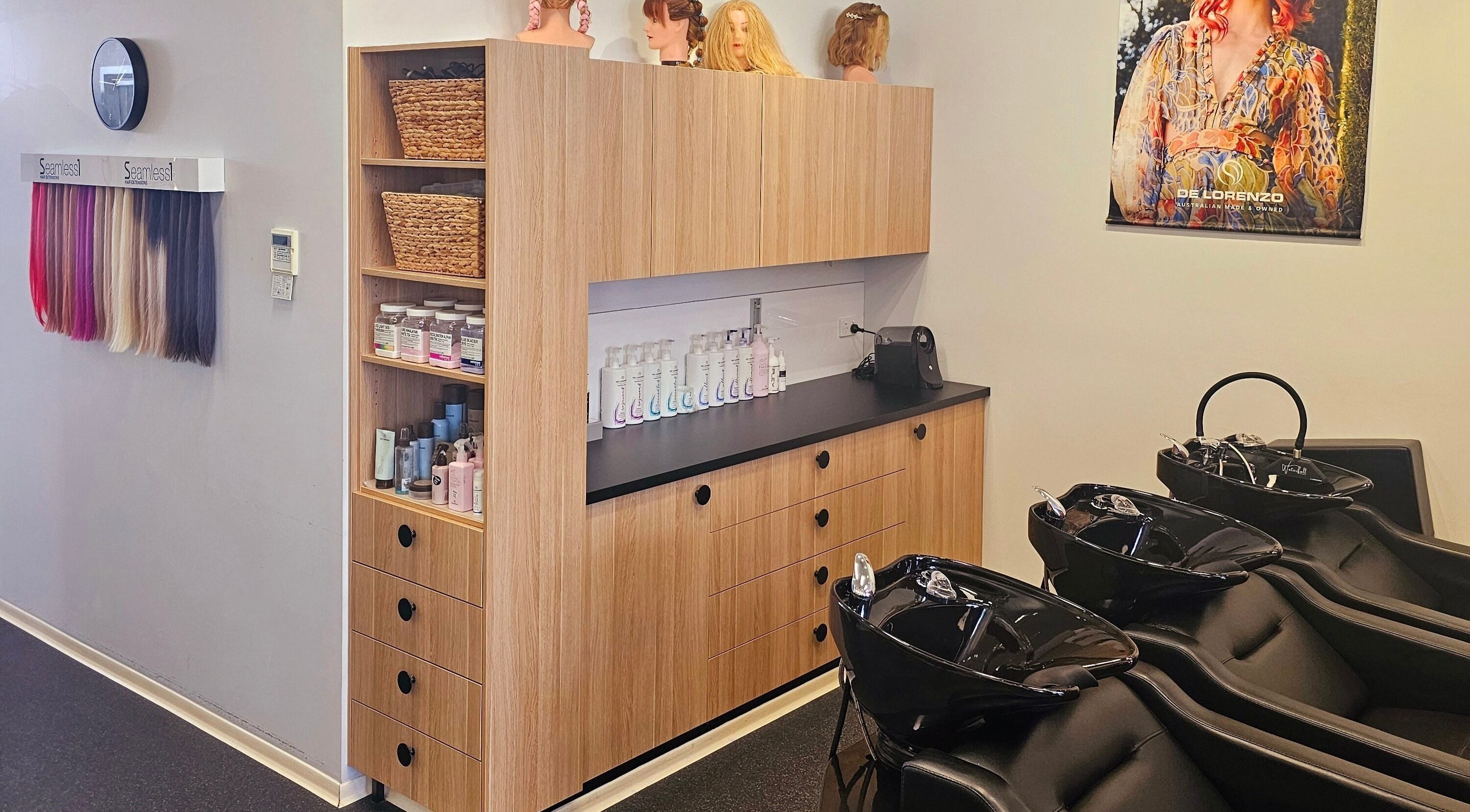 Modern hair care area at Salt Hair and Beauty Design, Budgewoi, New South Wales, AU, with sleek washbasins.