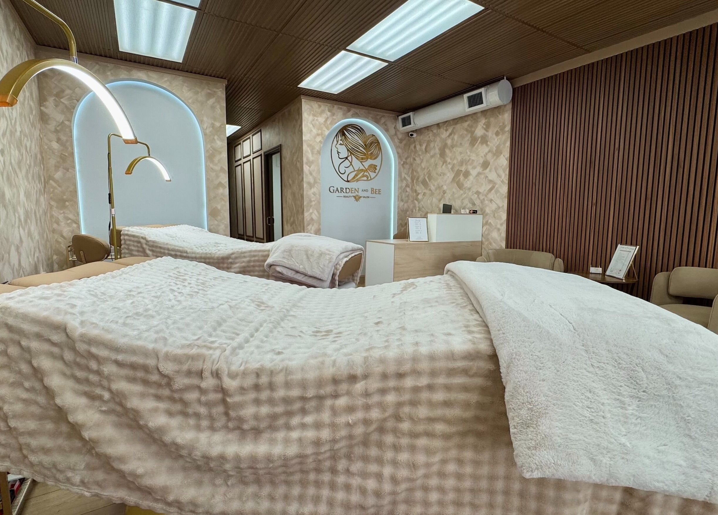 Luxurious massage room at Garden and Bee in Eatontown, New Jersey, US with cozy beds and elegant decor.