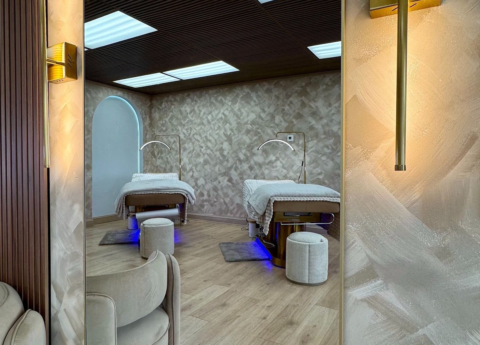 Relaxing spa room at Garden and Bee, Eatontown, New Jersey, US, featuring cozy treatment beds and elegant lighting.