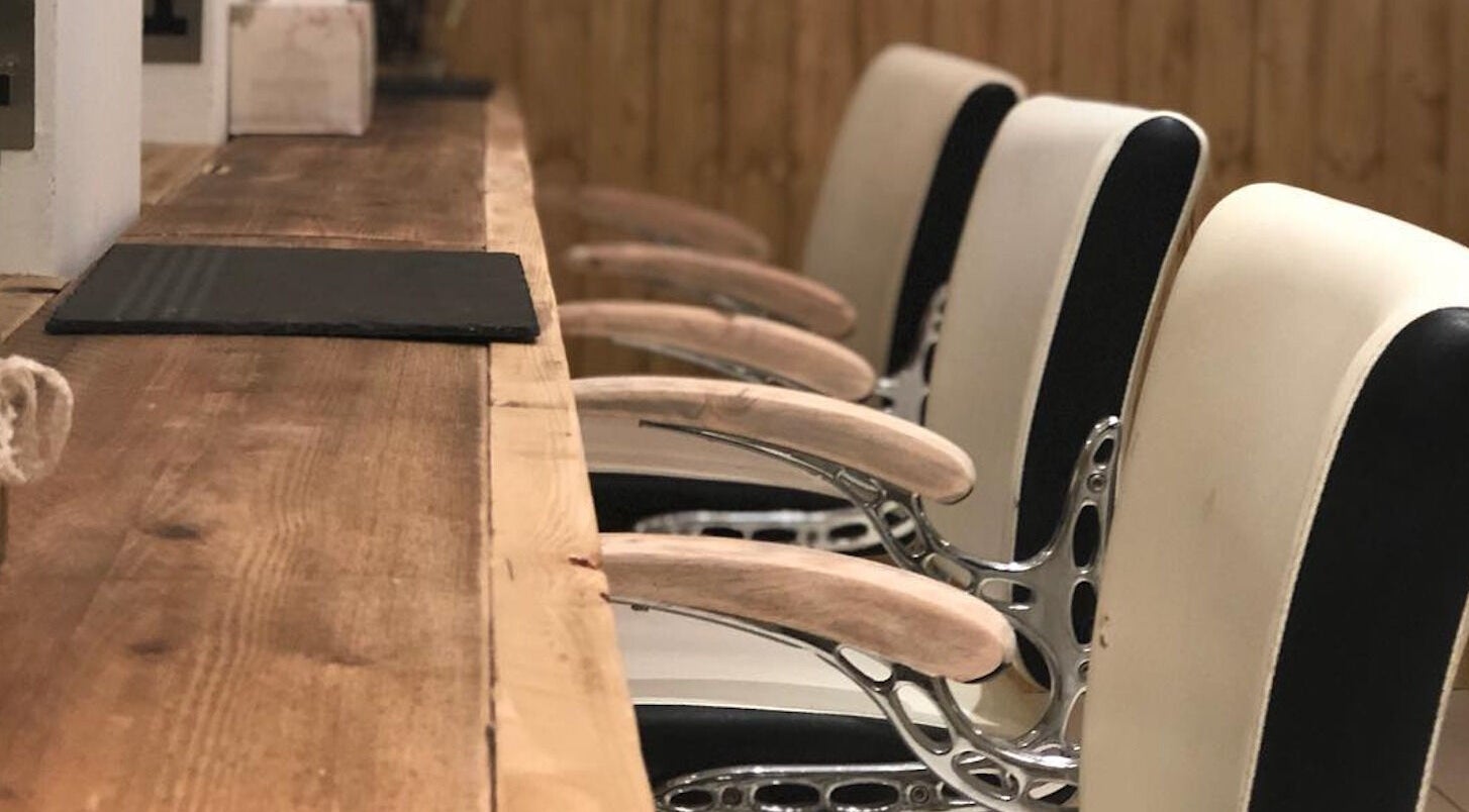 Elegant salon chairs at The Root in Harpenden, England, GB create a luxurious beauty experience.